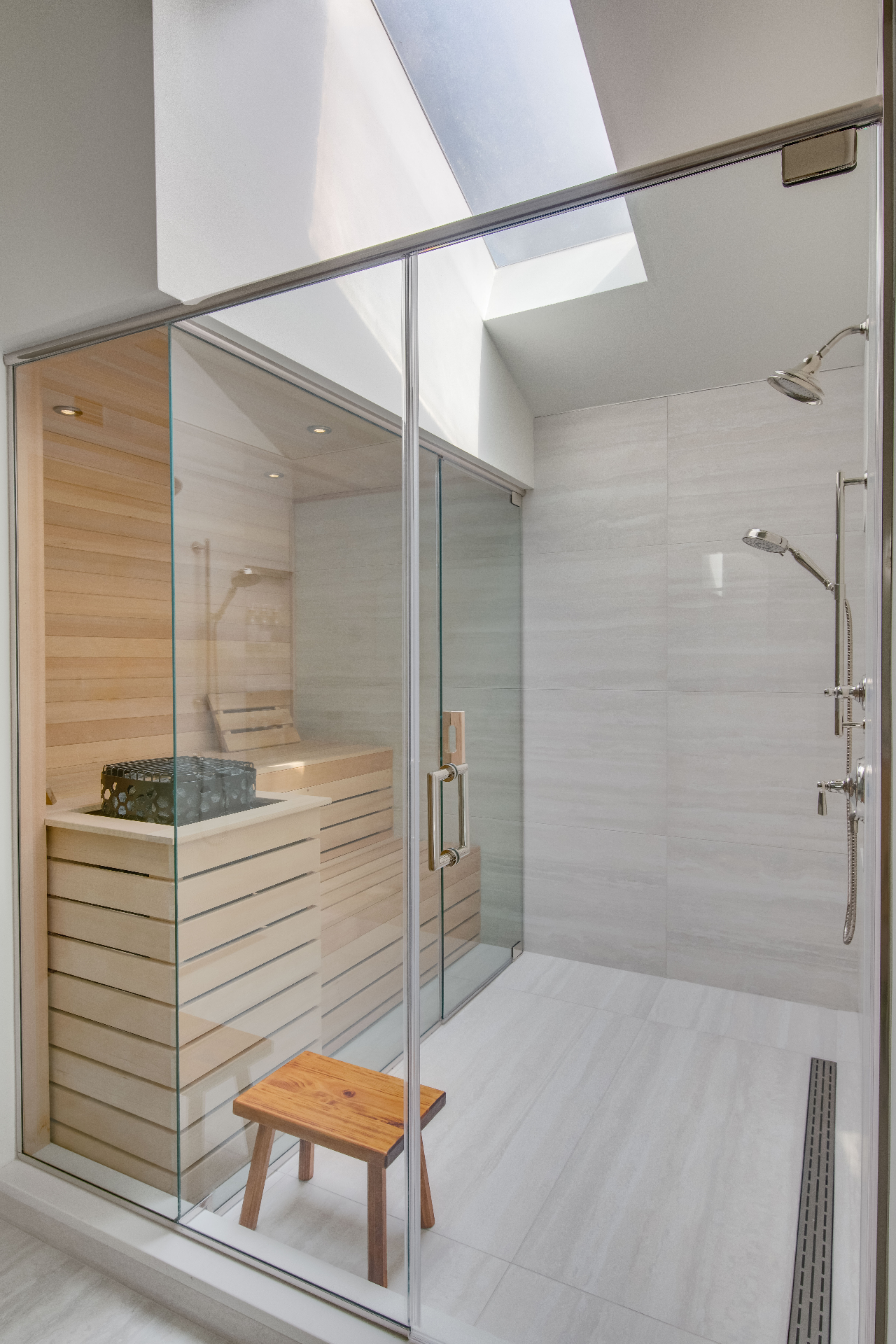 Glass-front sauna with refined lighting and steam