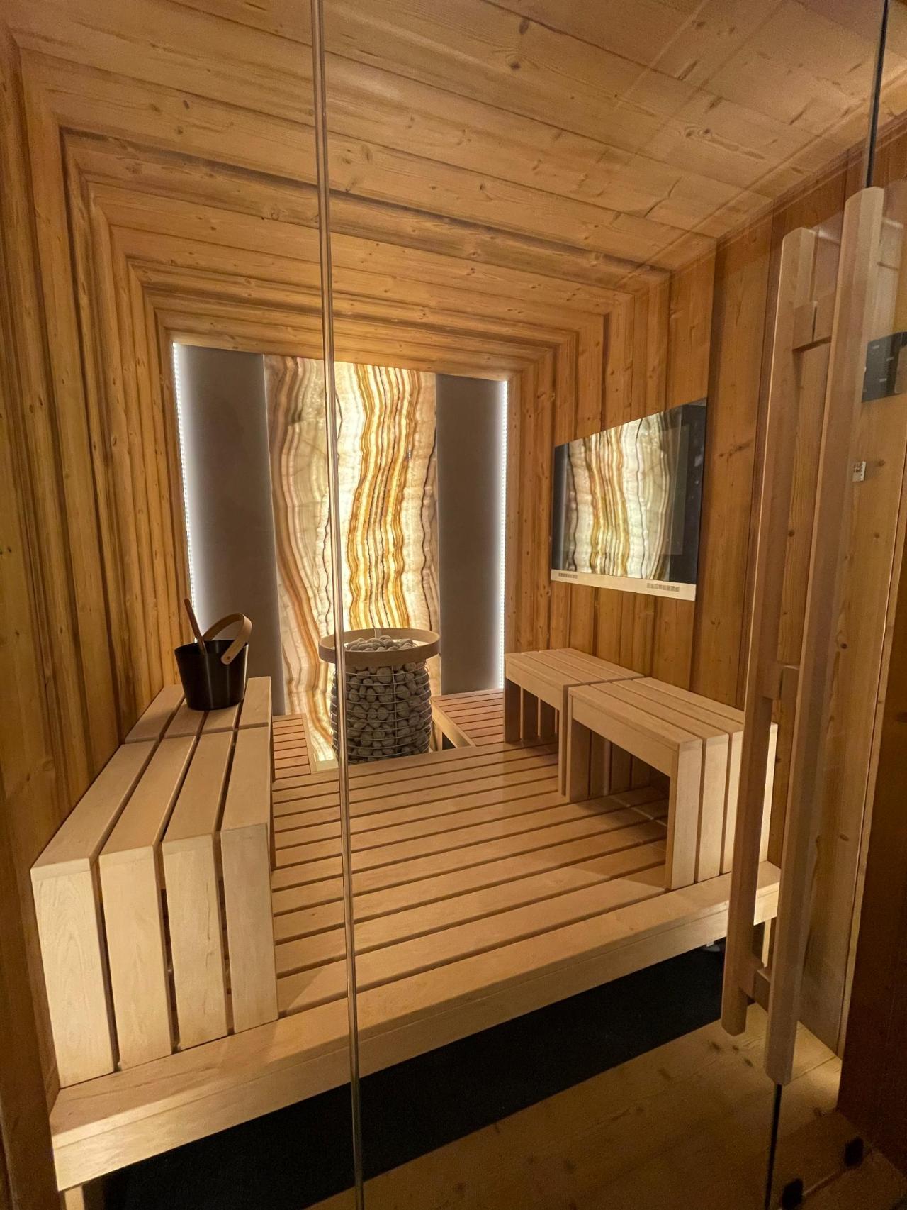 Warm cedar interior with backlit onyx column