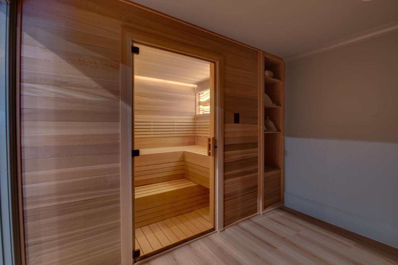 Custom indoor sauna with glass door and light hemlock interior