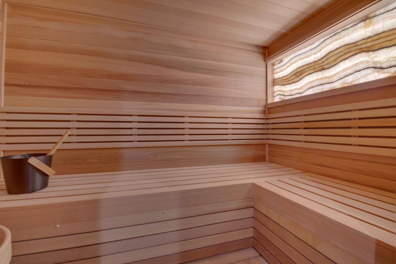 Calm light wood sauna interior with backlit onyx detail